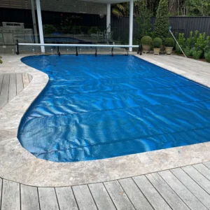 Covered backyard pool with deck area.