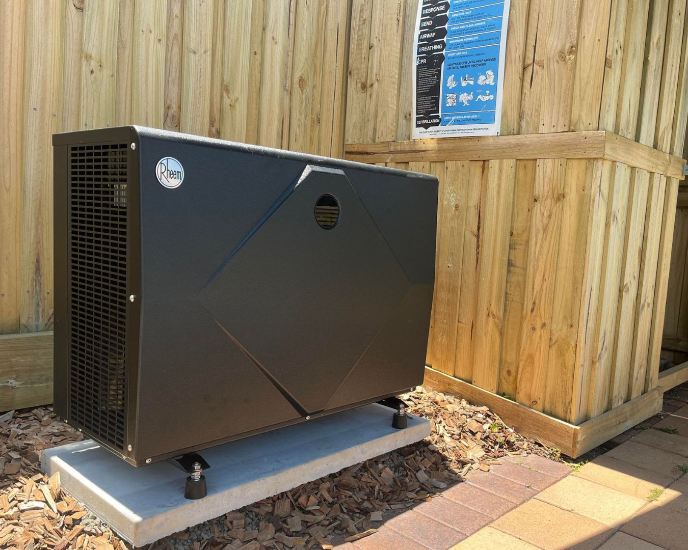 Outdoor Rheem heat pump on concrete slab