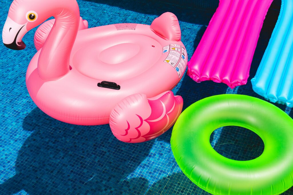 Inflatable pool floats on blue water surface.