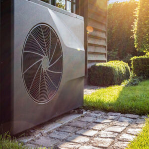 Outdoor heat pump unit next to modern house